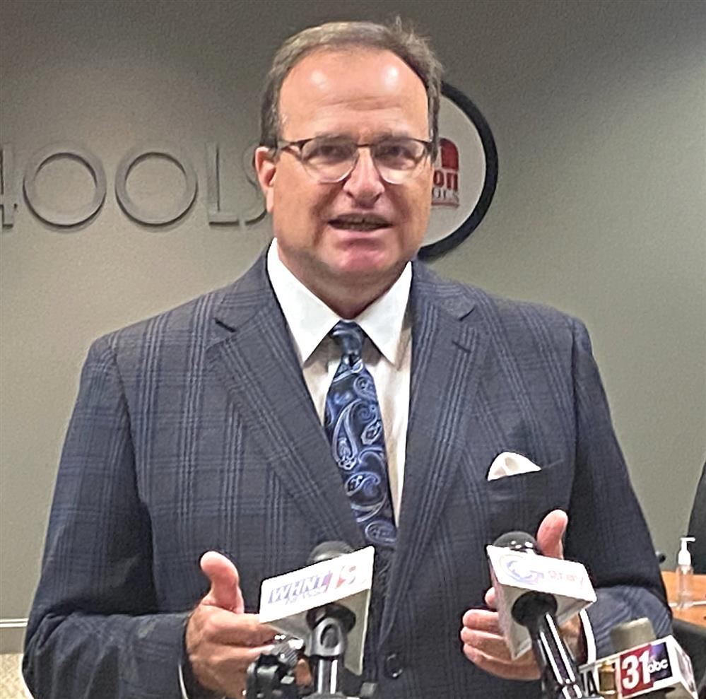  mug shot of Dr. Ed Nichols at podium